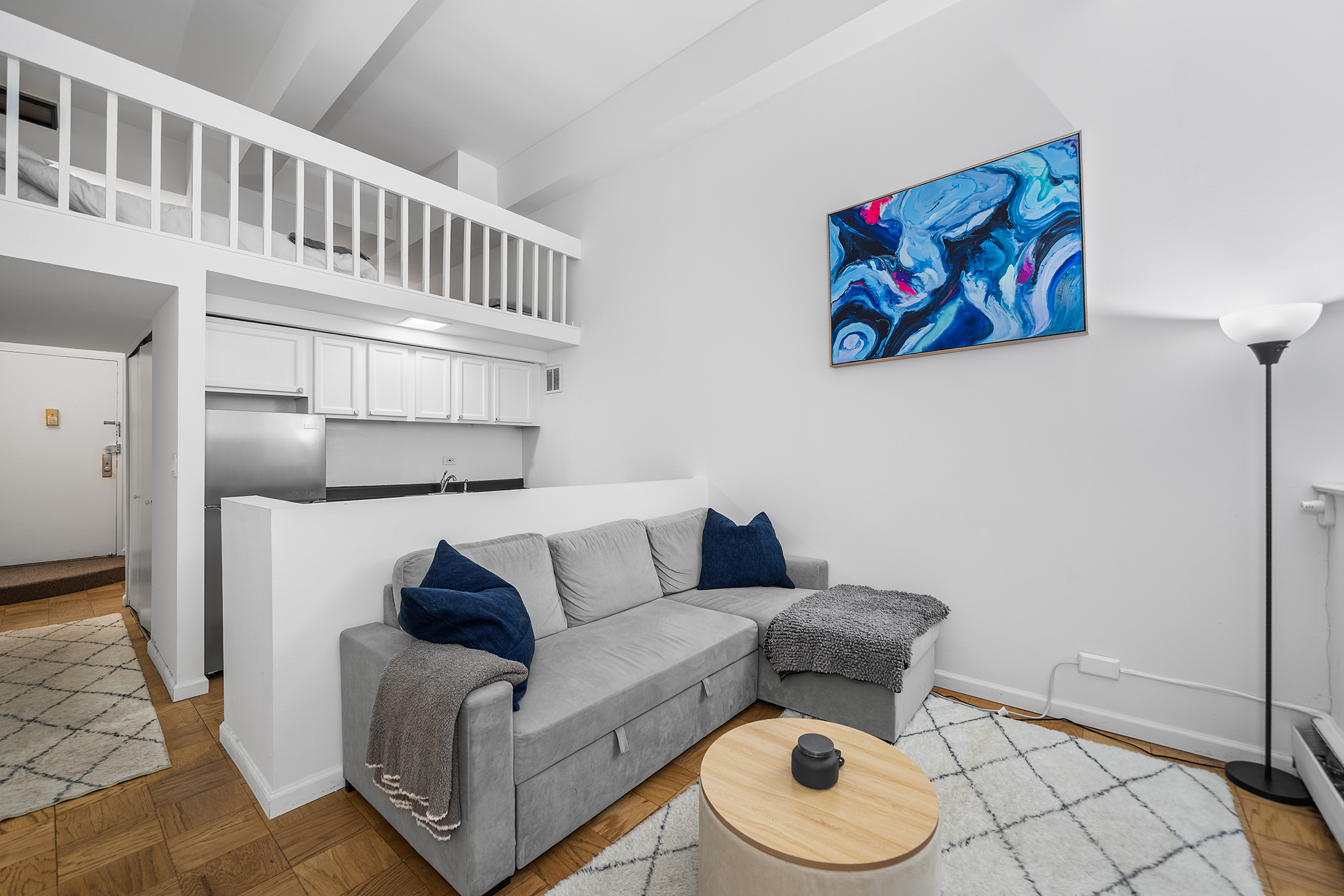 350 East 62nd Street, Unit 1M Manhattan, NY 10065 - Photo 6 of 18 a living room with furniture and a rug