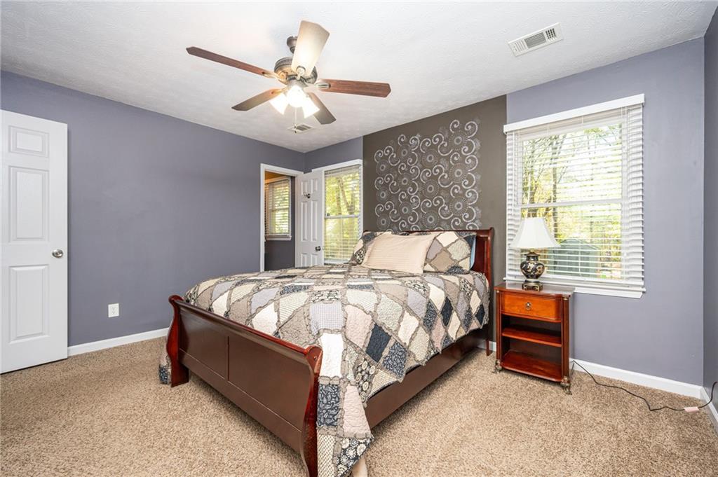 70 Countryside Lane Covington, GA 30016 - Photo 17 of 30 a bed sitting in a bedroom next to a window