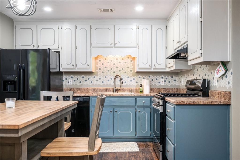 70 Countryside Lane Covington, GA 30016 - Photo 9 of 30 a kitchen with stainless steel appliances granite countertop a sink stove and refrigerator