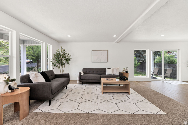 1552 Sumac Drive Logan, UT 84321 - Photo 6 of 72 Spacious living area featuring large windows, sliding glass door access to the exterior, recessed lighting, and a combination of carpet and wood-finish flooring