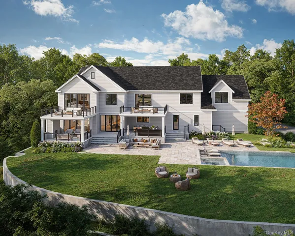a view of a house with swimming pool and sitting area