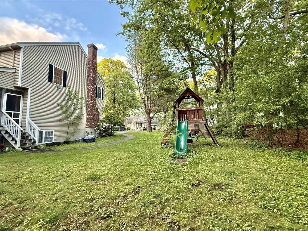 19 Fairview Road, Unit A Framingham, MA 01702 - Photo 2 of 28 a backyard of a house with table and chairs
