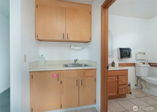 a view of cabinets with wooden floor washer and dryer