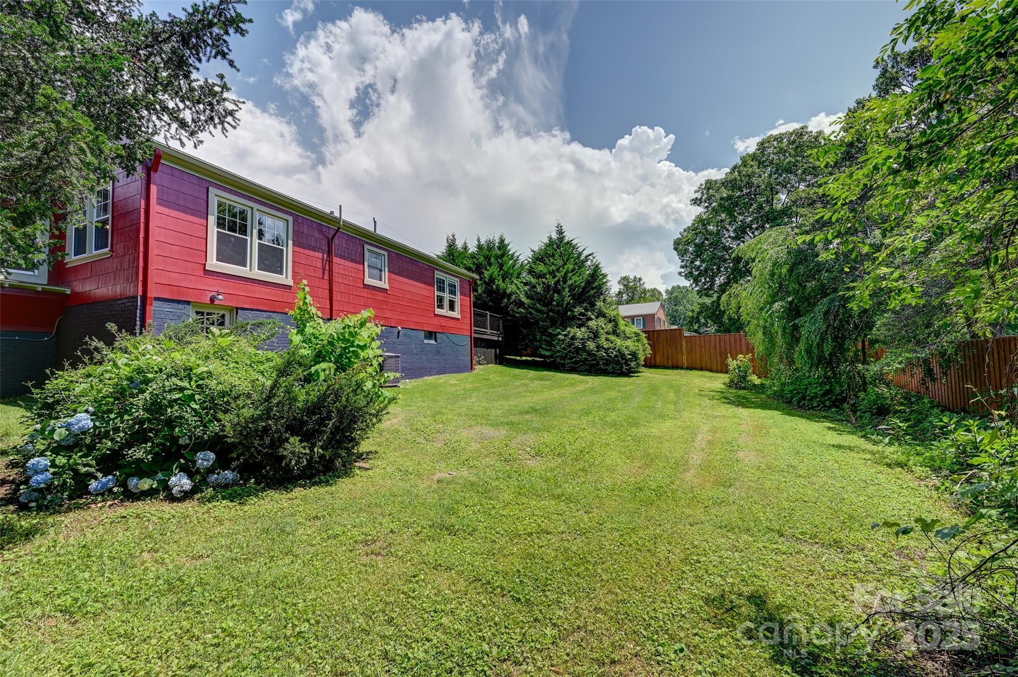 14 Monroe Street Brevard, NC 28712 - Photo 20 of 48 a view of a big yard with potted plants and large trees