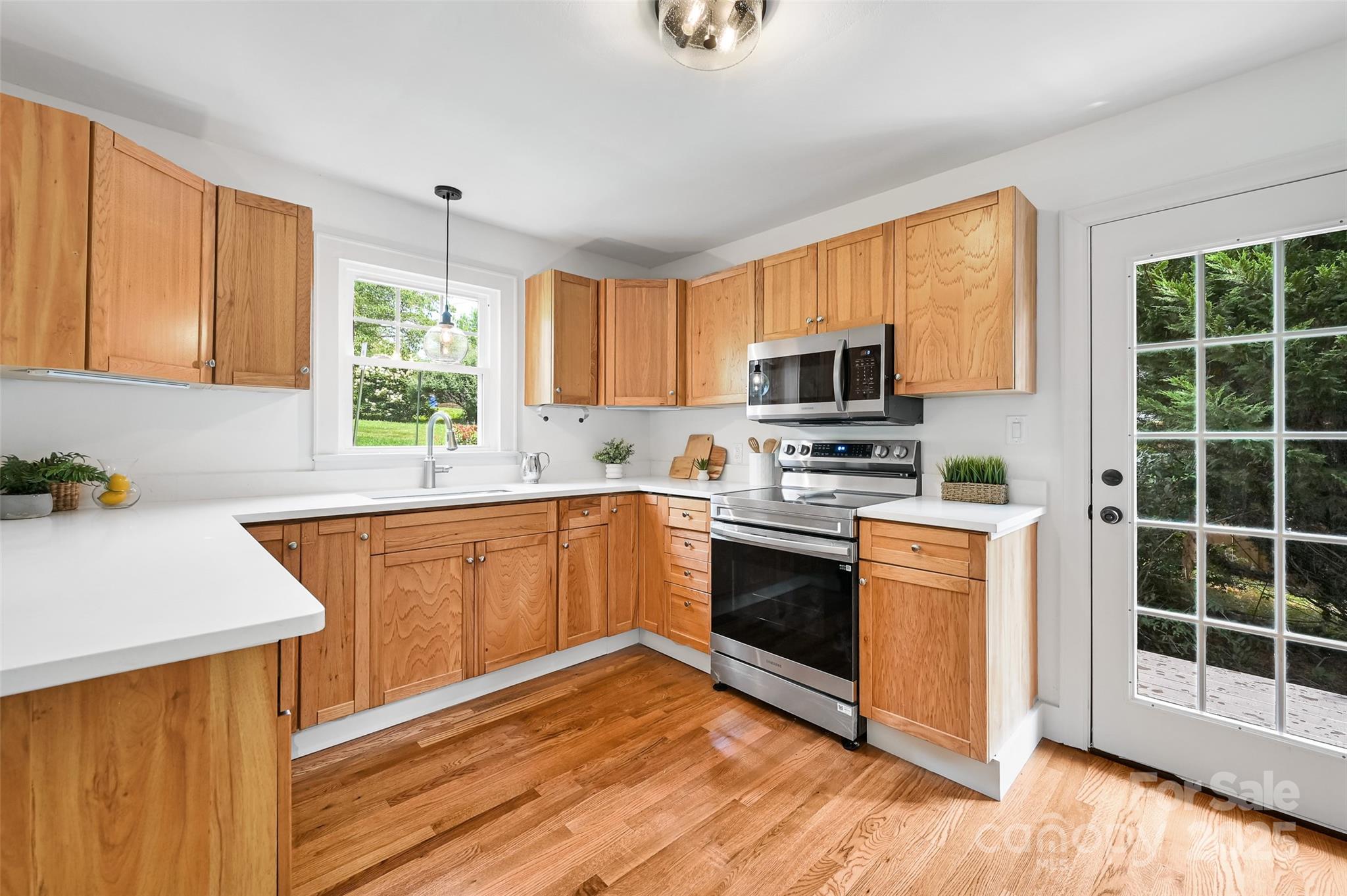 14 Monroe Street Brevard, NC 28712 - Photo 36 of 48 a kitchen with granite countertop a stove a sink and a microwave