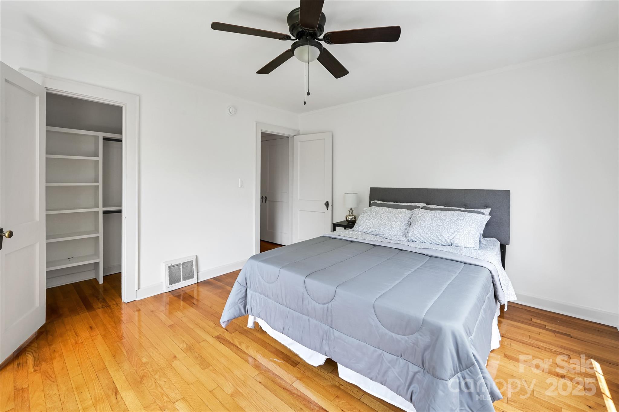 14 Monroe Street Brevard, NC 28712 - Photo 44 of 48 a bedroom with a bed and a chandelier