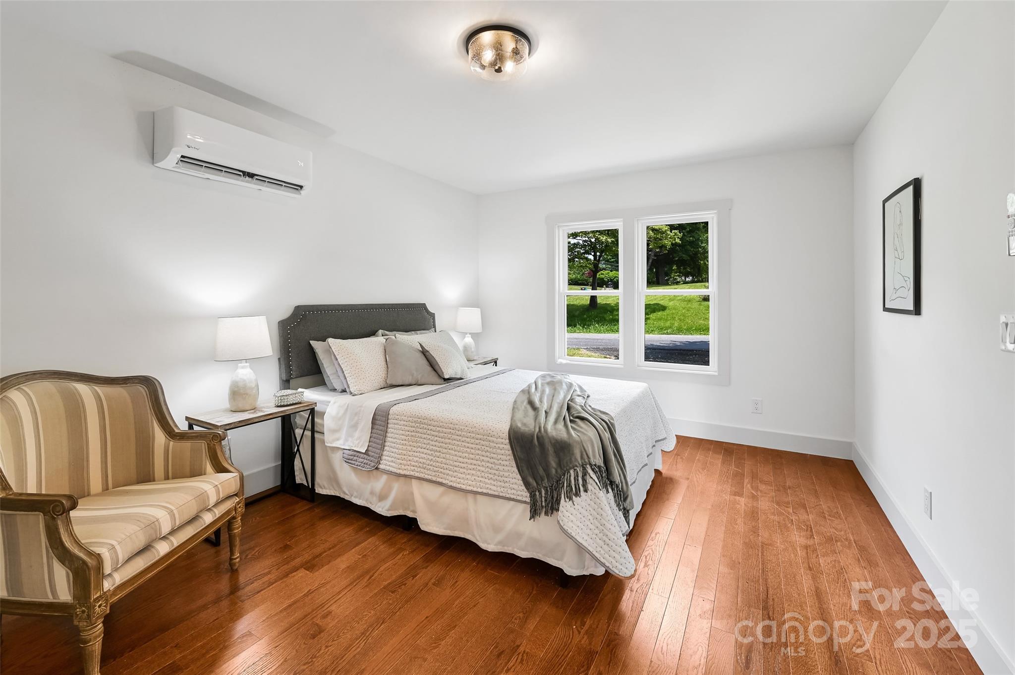 14 Monroe Street Brevard, NC 28712 - Photo 46 of 48 a bedroom with a bed and wooden floor