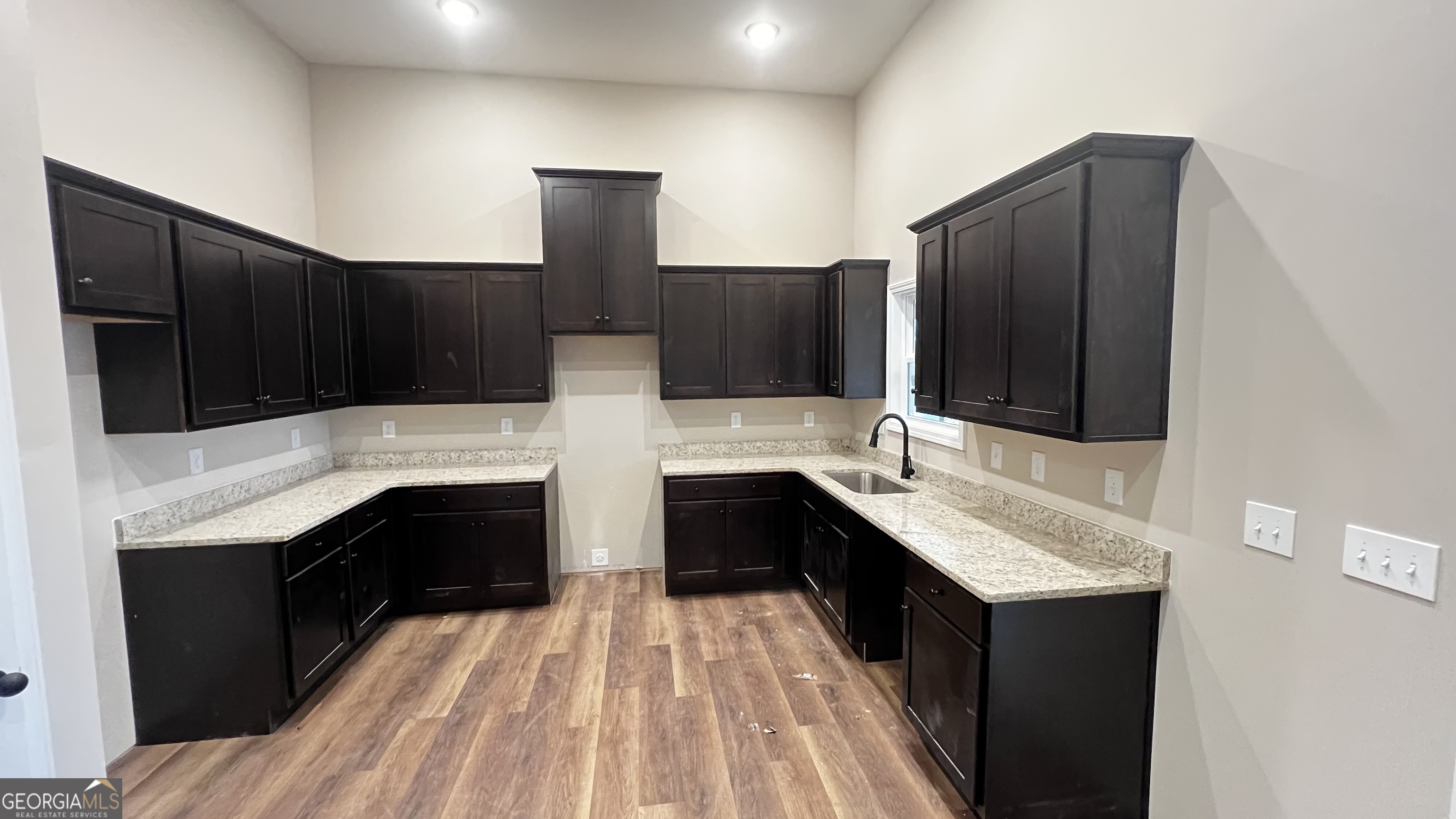 187 Coffey Road Barnesville, GA 30204 - Photo 6 of 27 a kitchen with stainless steel appliances kitchen island granite countertop a sink stove and refrigerator