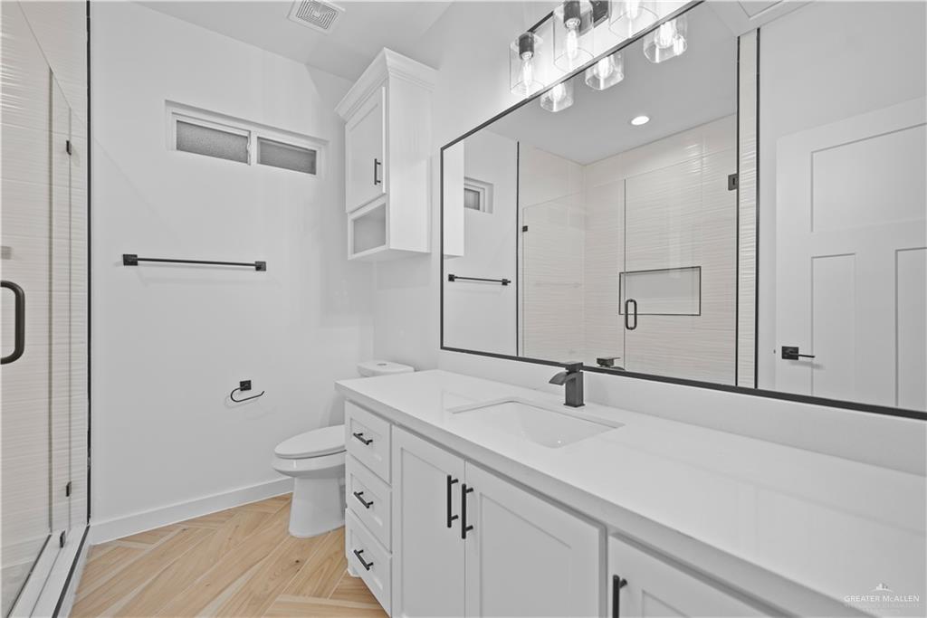 2728 East Conroe Road Edinburg, TX 78542 - Photo 11 of 14 a bathroom with a sink a toilet and shower