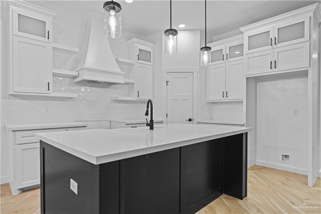 2728 East Conroe Road Edinburg, TX 78542 - Photo 6 of 14 a kitchen with white cabinets and sink
