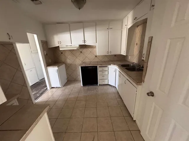 a kitchen with stainless steel appliances a stove a sink and a refrigerator