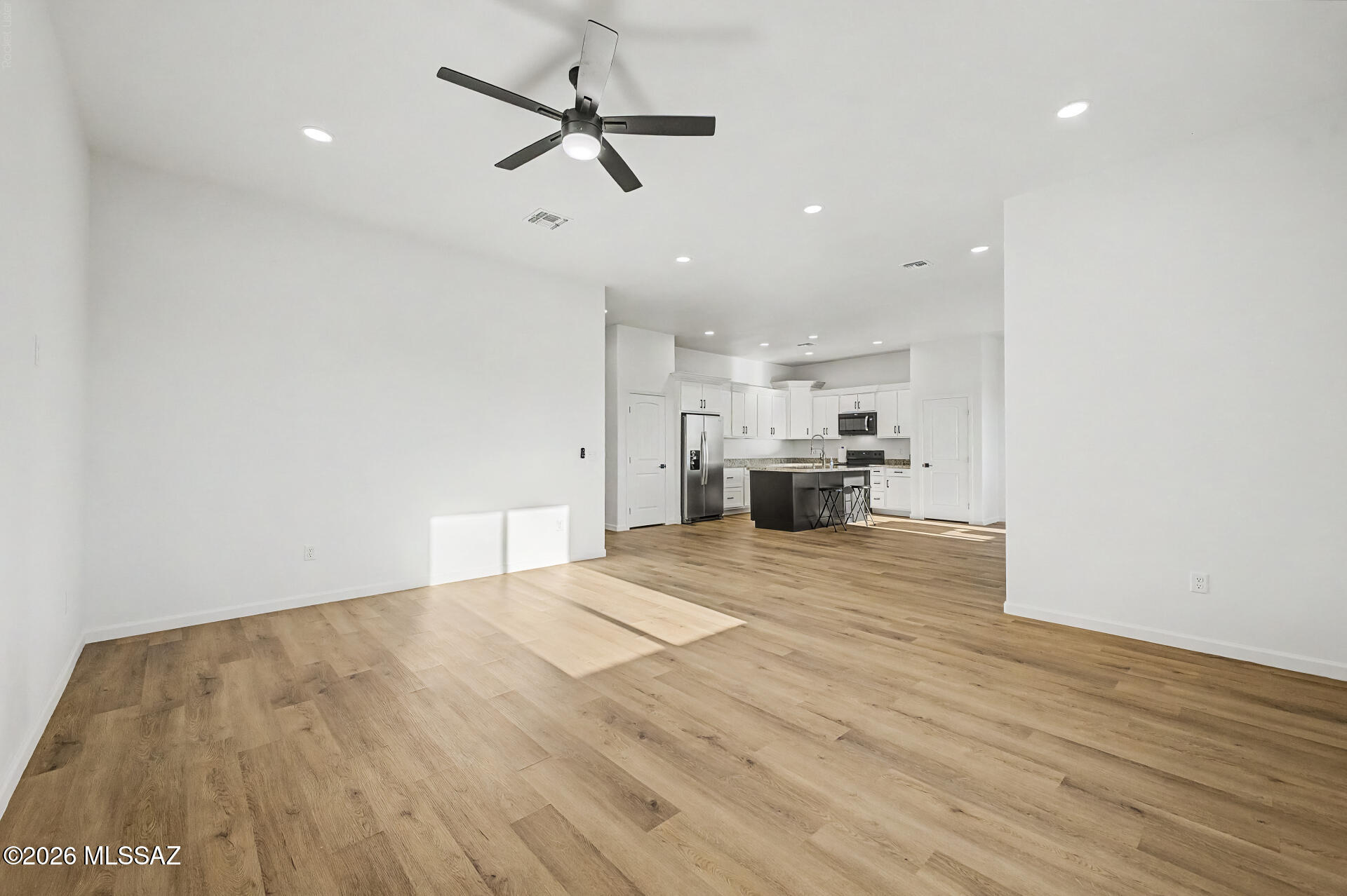 4601 East Magoo Road Tucson, AZ 85739 - Photo 9 of 38 a view of empty room with wooden floor and ceiling fan