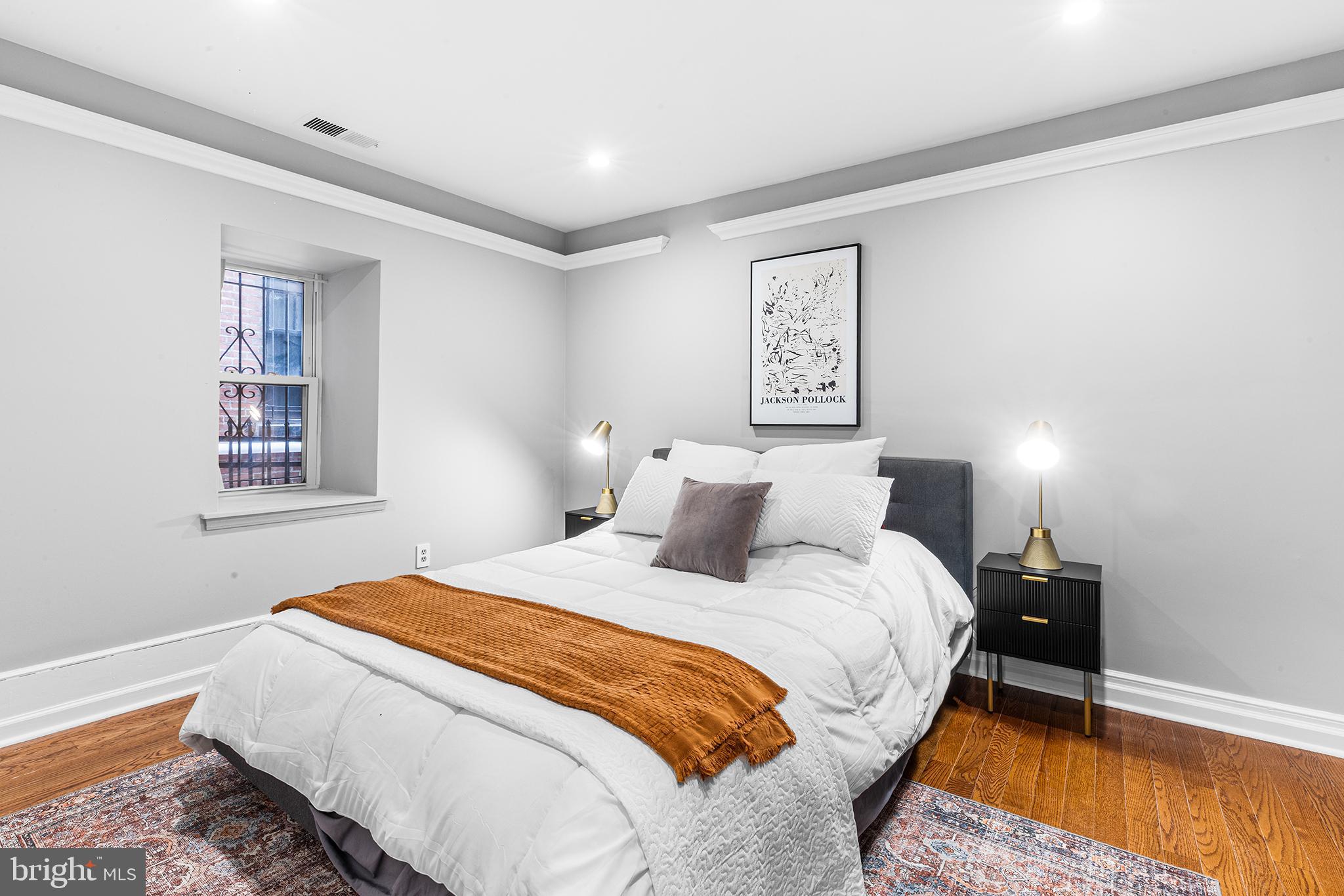 1903 Spruce Street, Unit 1A Philadelphia, PA 19103 - Photo 11 of 22 a bedroom with a bed and painting on the wall