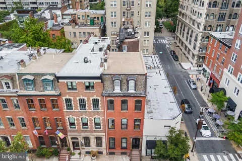 aerial view of a brick building next to a large building