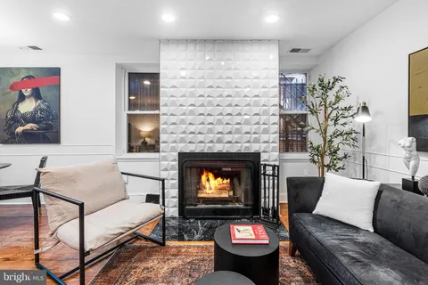 a living room with furniture and a fireplace