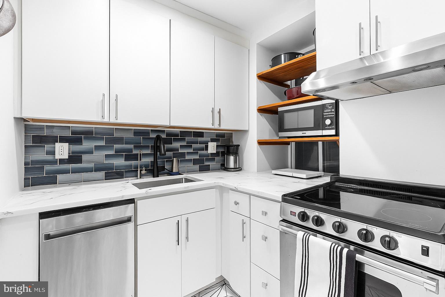 1903 Spruce Street, Unit 1A Philadelphia, PA 19103 - Photo 7 of 22 a kitchen with stainless steel appliances granite countertop a sink stove and cabinets