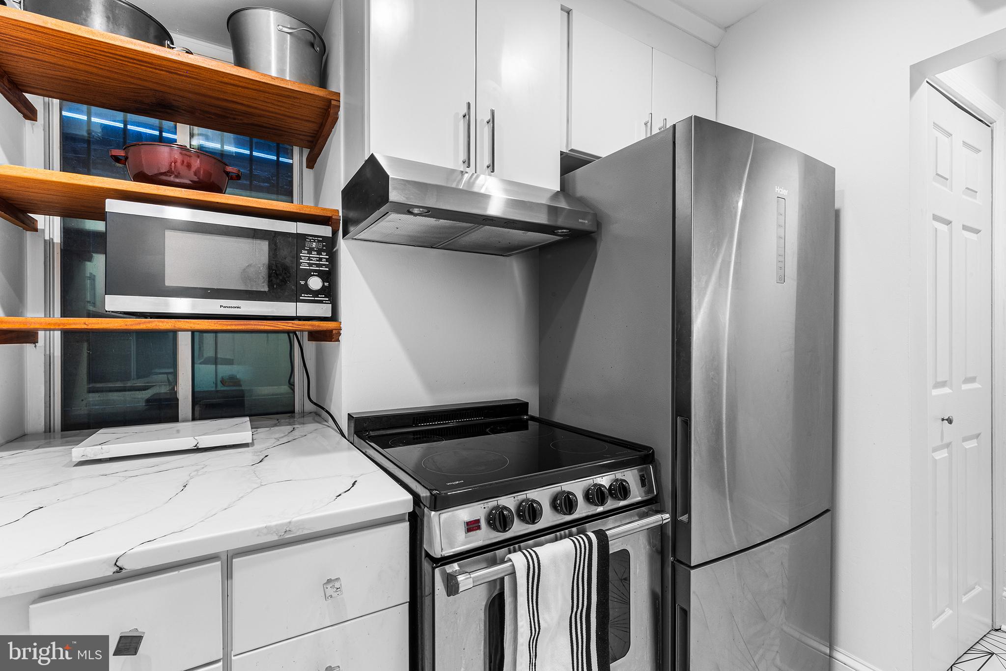 1903 Spruce Street, Unit 1A Philadelphia, PA 19103 - Photo 9 of 22 a kitchen with stainless steel appliances granite countertop a refrigerator and a stove