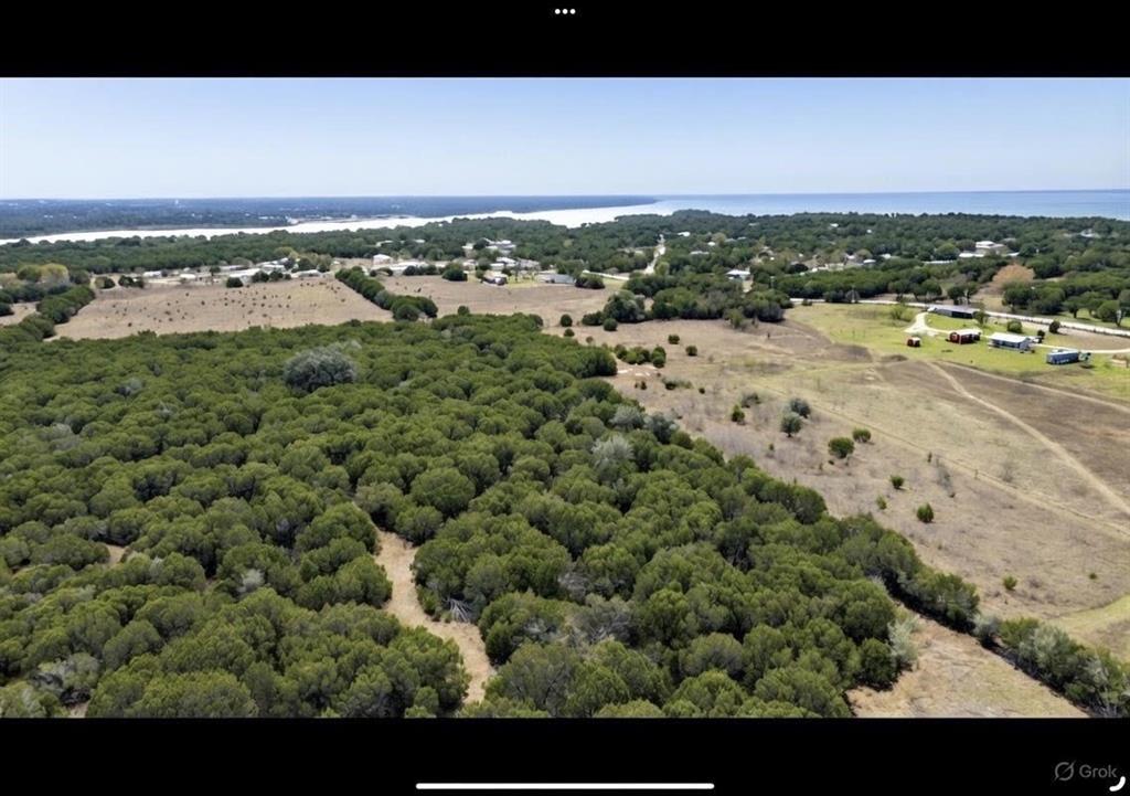 214 Cedar Creek Park Road Whitney, TX 76692 - Photo 7 of 32 Overview of rural landscape with a nearby body of water and a heavily wooded area