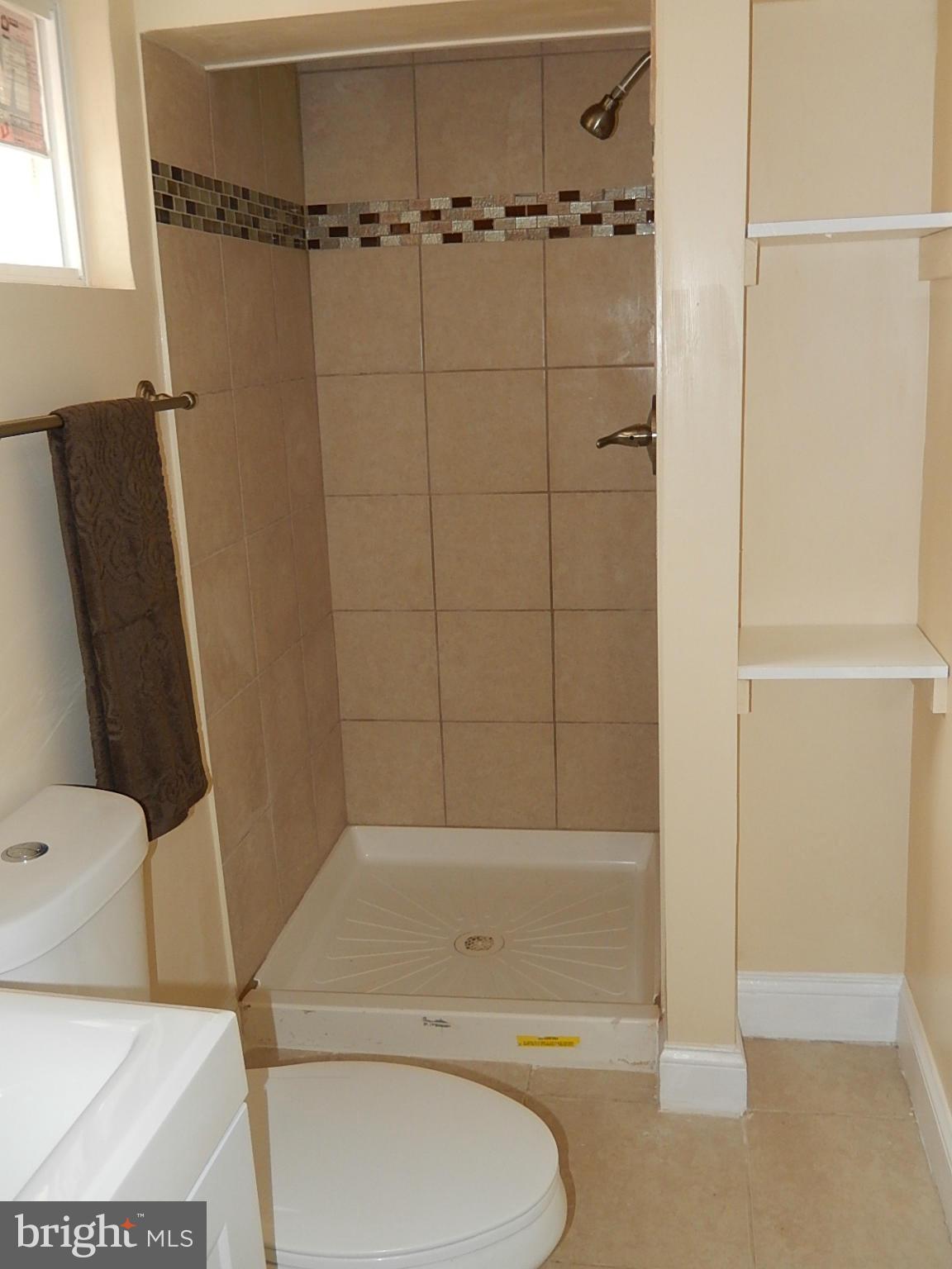 622 Warwick Road Baltimore, MD 21229 - Photo 18 of 29 a bathroom with a shower and a toilet