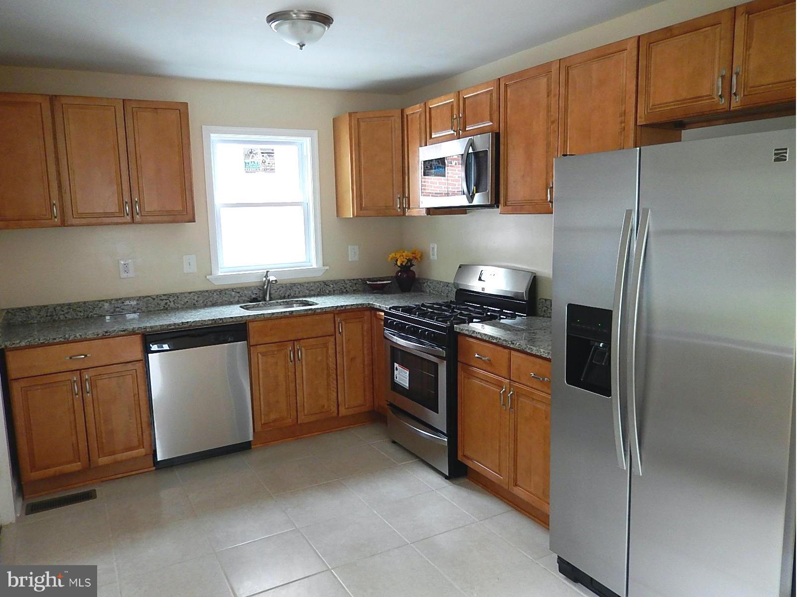 622 Warwick Road Baltimore, MD 21229 - Photo 3 of 29 a kitchen with stainless steel appliances granite countertop a refrigerator and a sink
