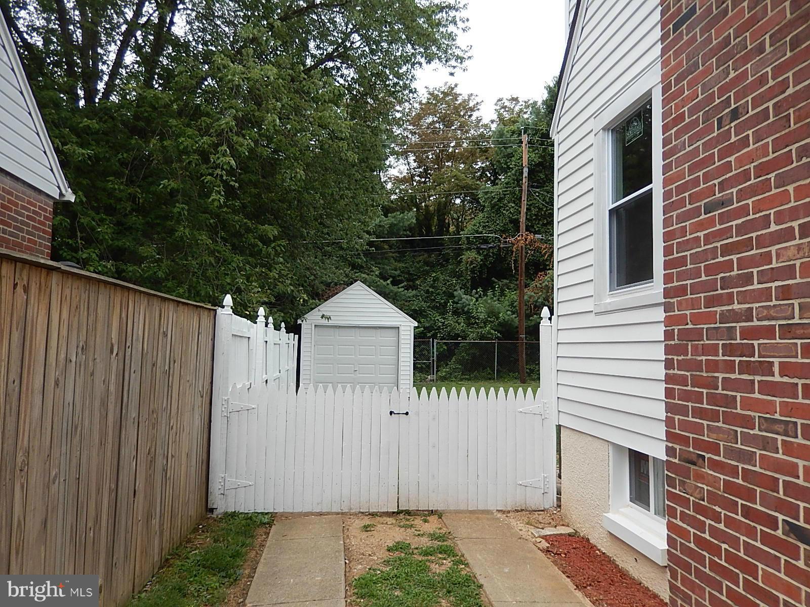 622 Warwick Road Baltimore, MD 21229 - Photo 26 of 29 a front view of a house with a garage
