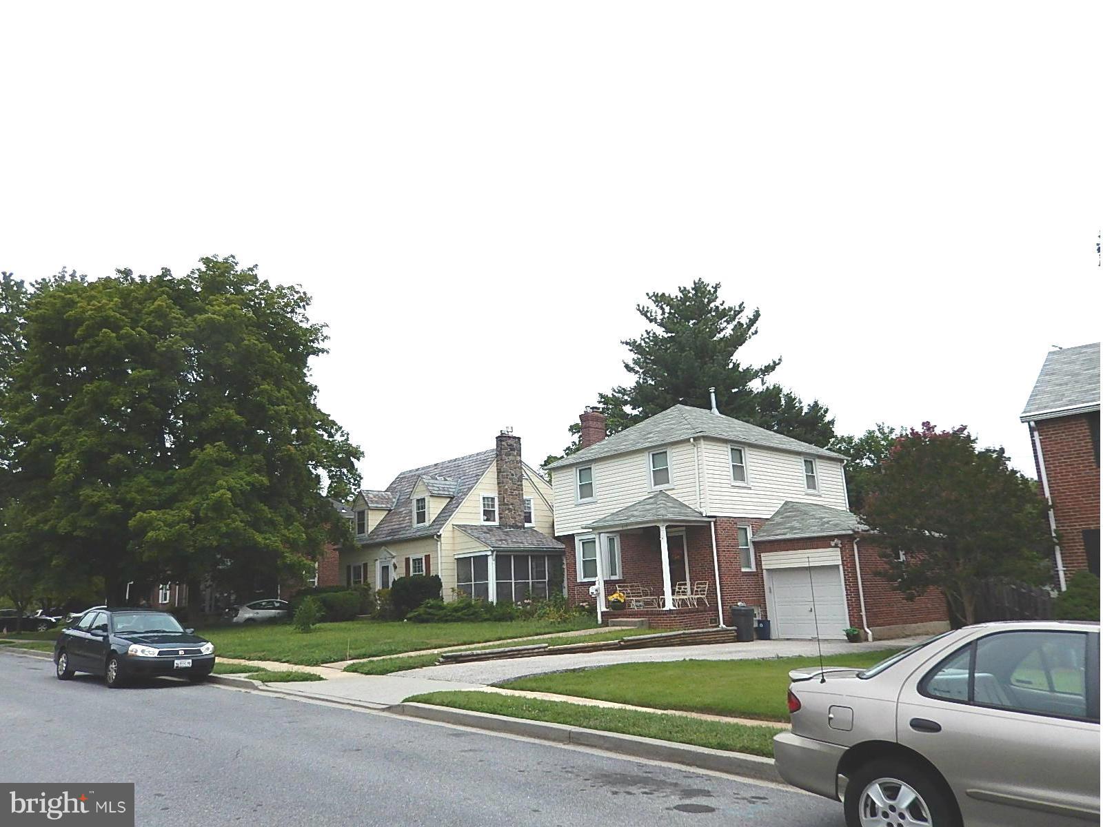 622 Warwick Road Baltimore, MD 21229 - Photo 27 of 29 a front view of a house with a garden and parking