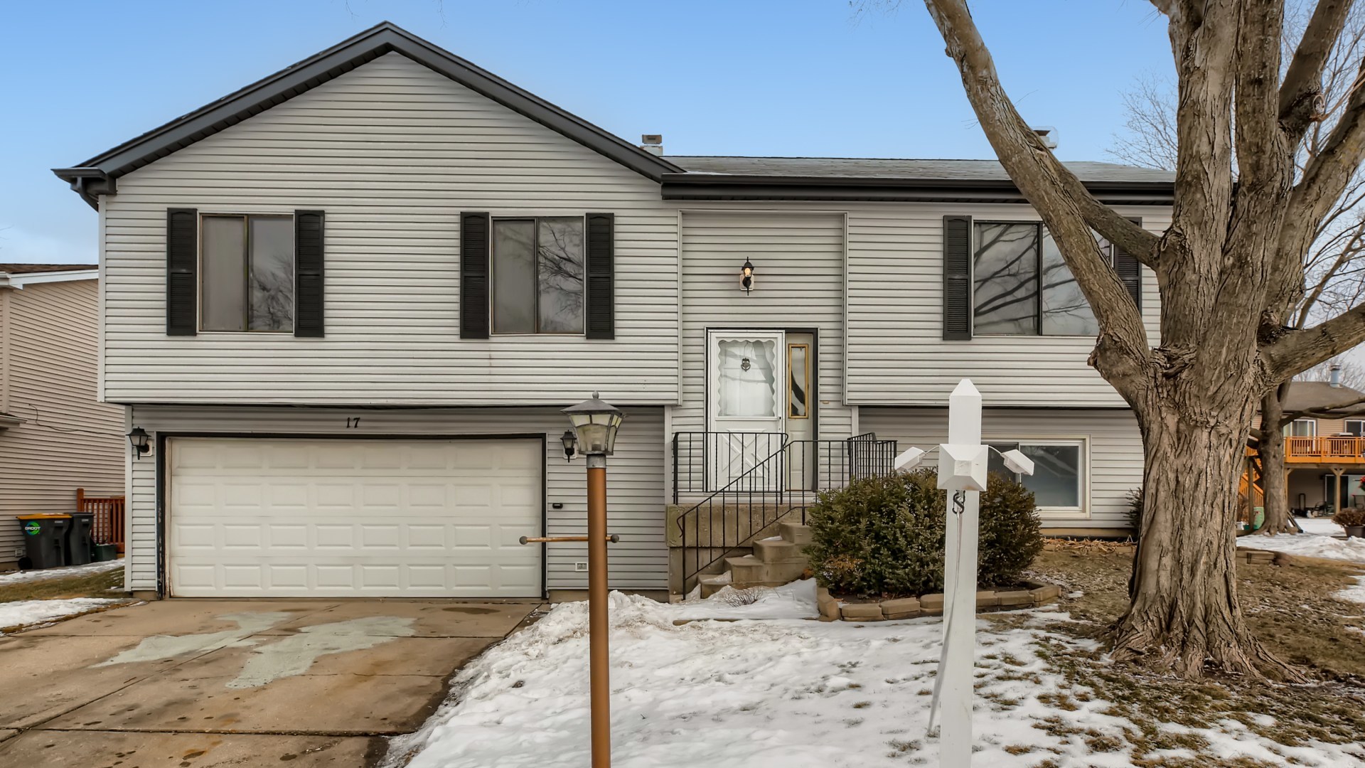 17 Windgate Court Streamwood, IL 60107 - Photo 1 of 28 a view of a house with a yard and large tree