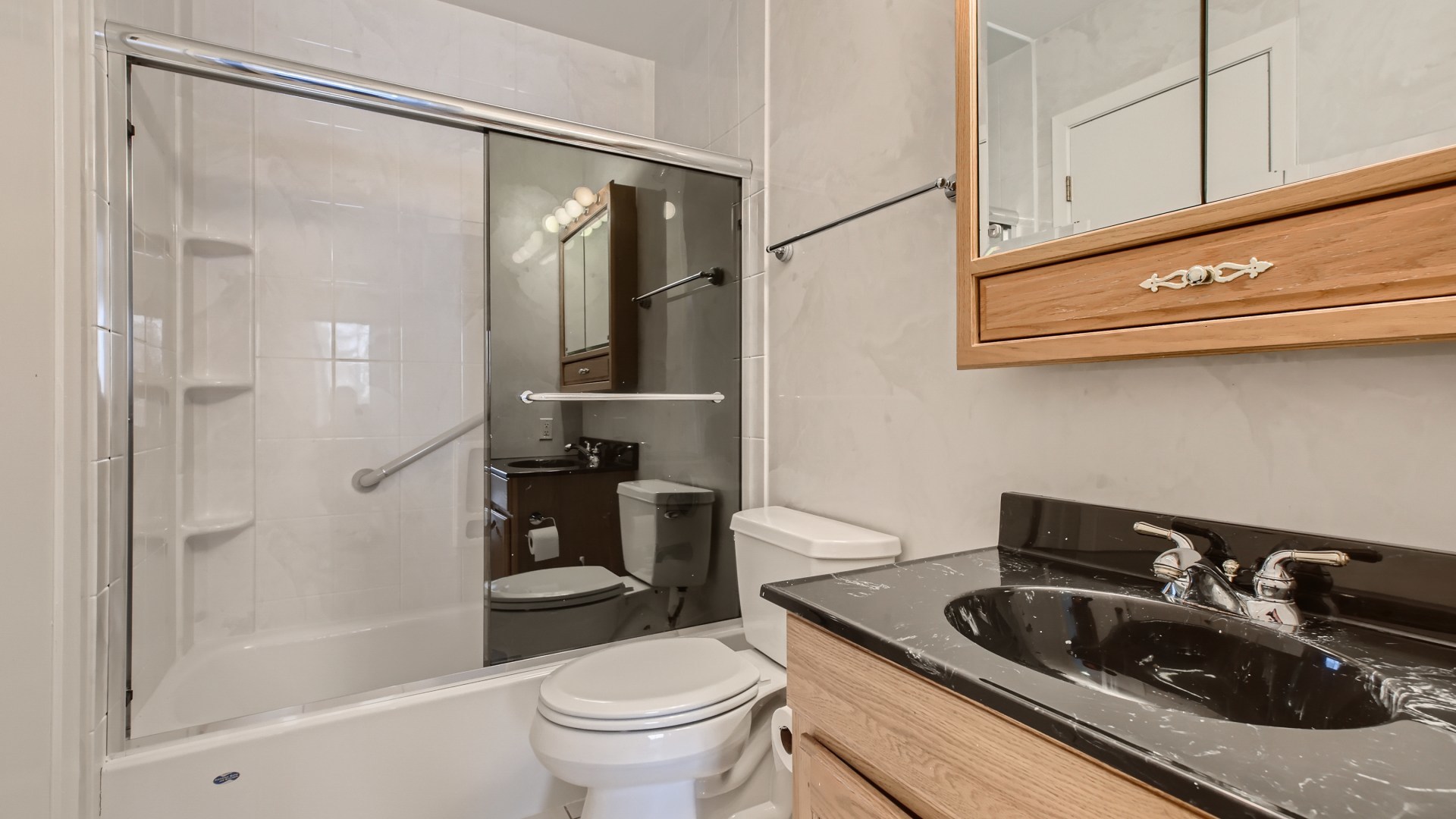 17 Windgate Court Streamwood, IL 60107 - Photo 15 of 28 a bathroom with a sink a toilet and shower