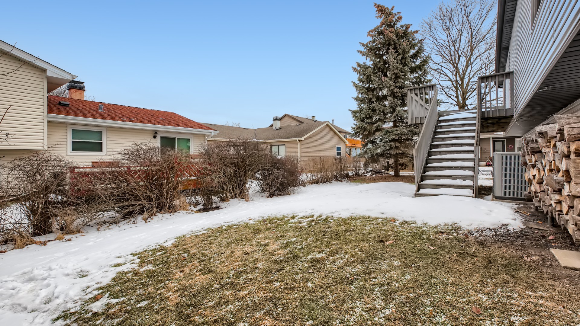 17 Windgate Court Streamwood, IL 60107 - Photo 27 of 28 a view of a house with a yard covered with snow in front of house