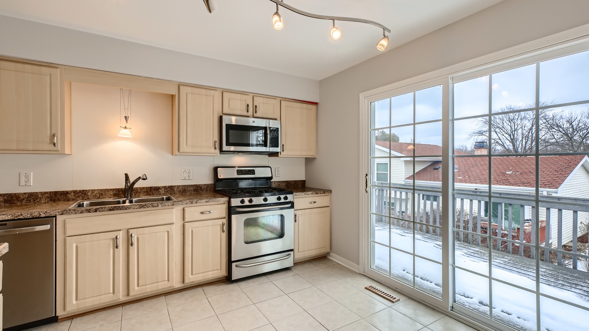 17 Windgate Court Streamwood, IL 60107 - Photo 9 of 28 a kitchen with stainless steel appliances granite countertop a stove a sink and white cabinets