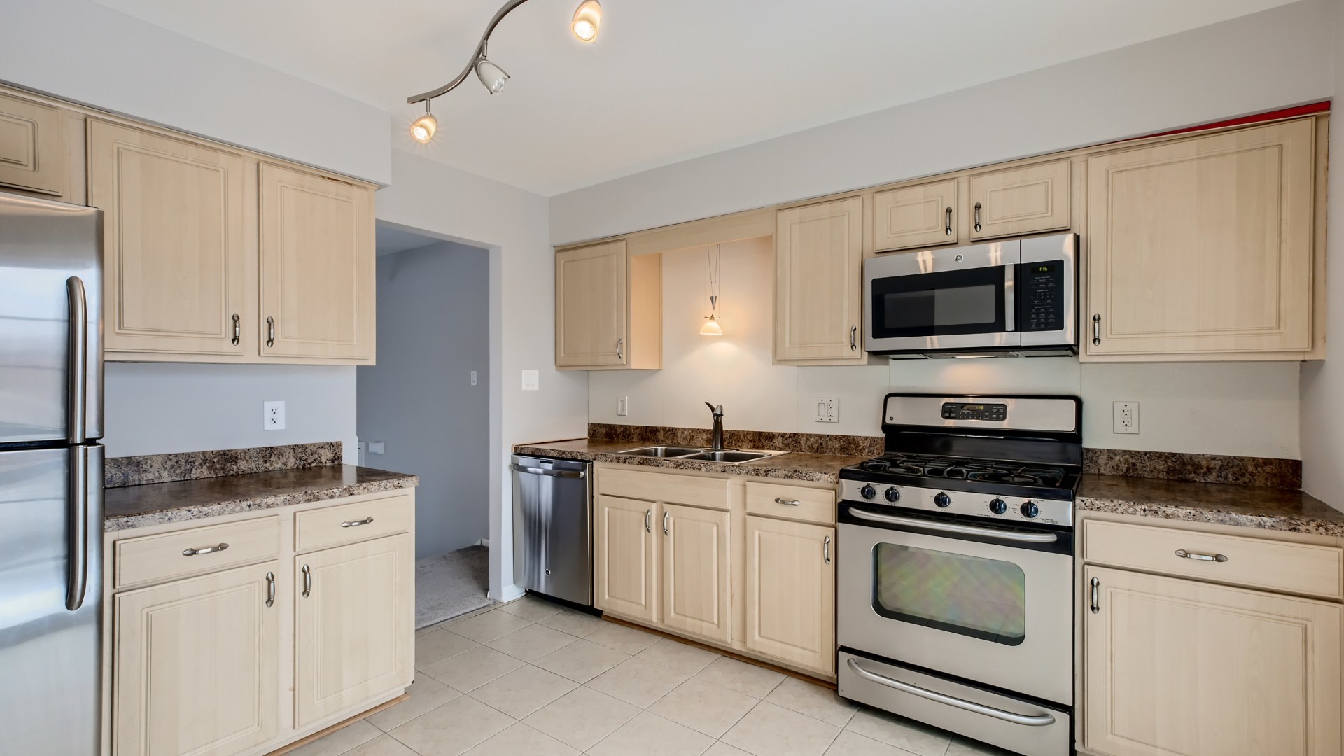 17 Windgate Court Streamwood, IL 60107 - Photo 10 of 28 a kitchen with granite countertop a stove top oven microwave and cabinets