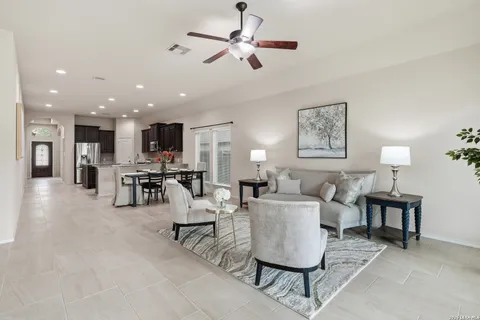 a living room with furniture and kitchen view