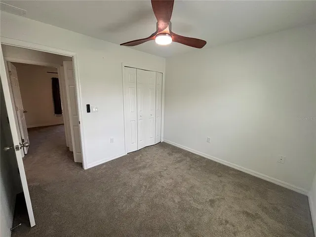 a view of an empty room with a fan