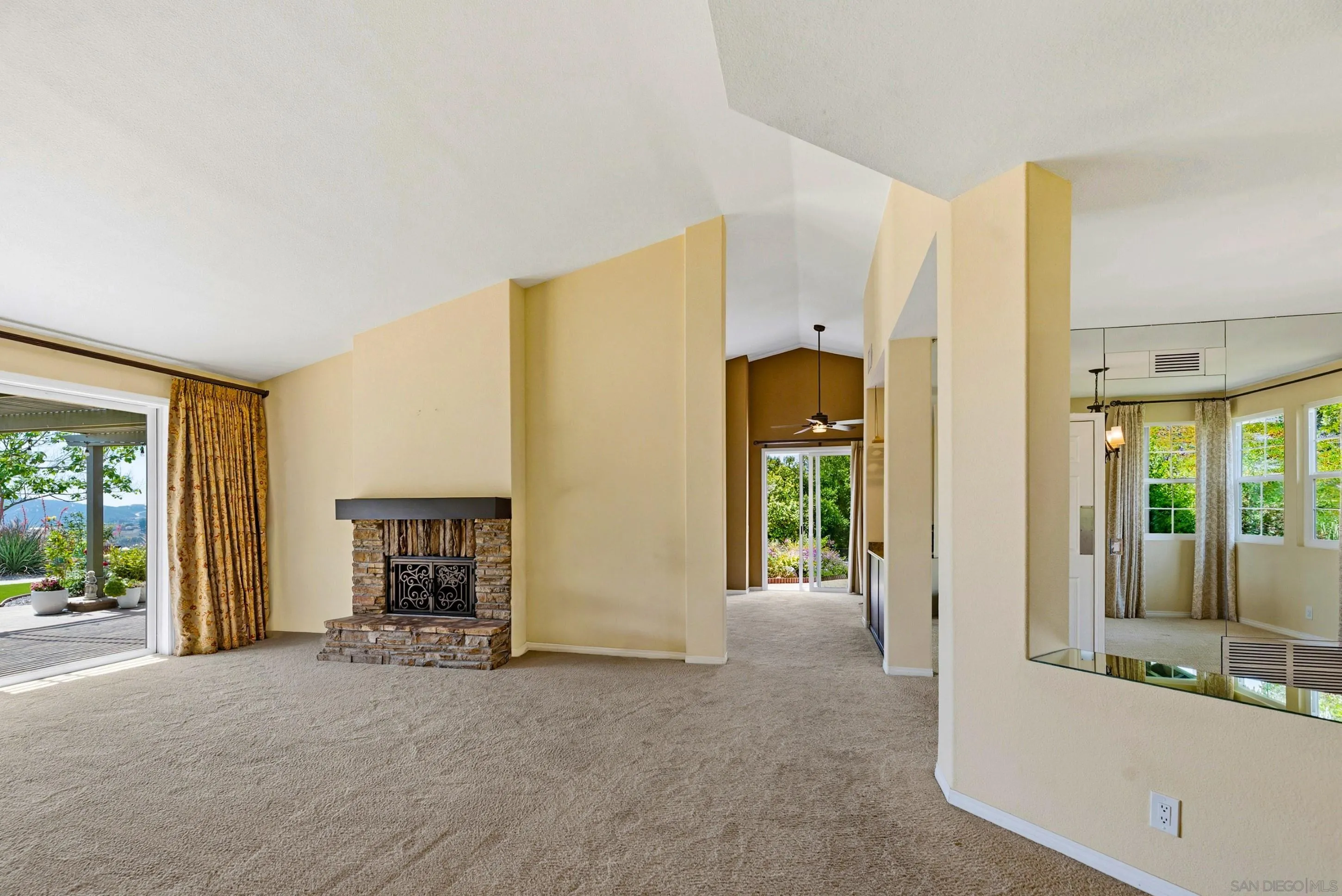 14505 Wildgrove Road Poway, CA 92064 - Photo 14 of 55 a view of an empty room with a fireplace and a window