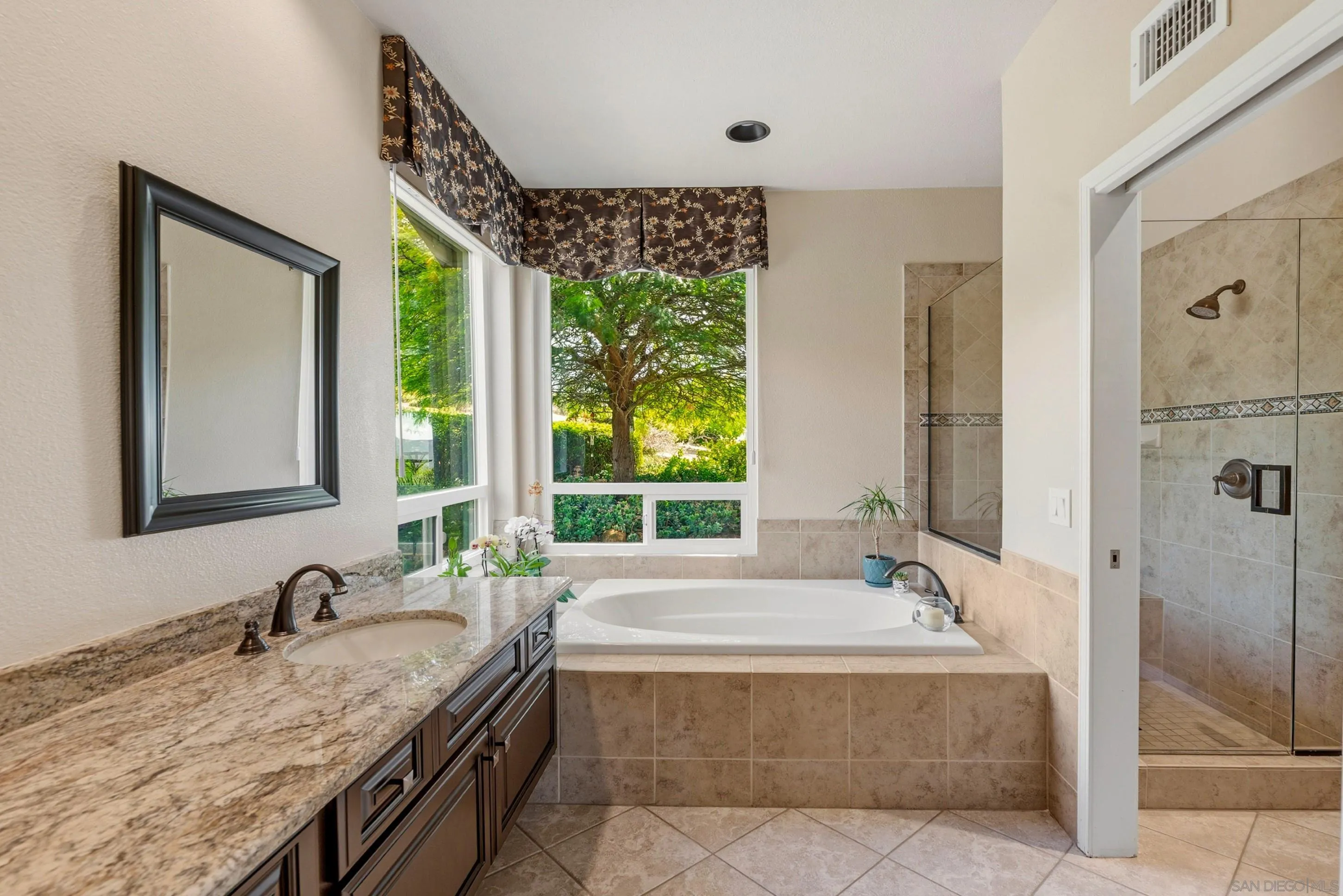 14505 Wildgrove Road Poway, CA 92064 - Photo 24 of 55 a bathroom with a granite countertop tub sink and mirror