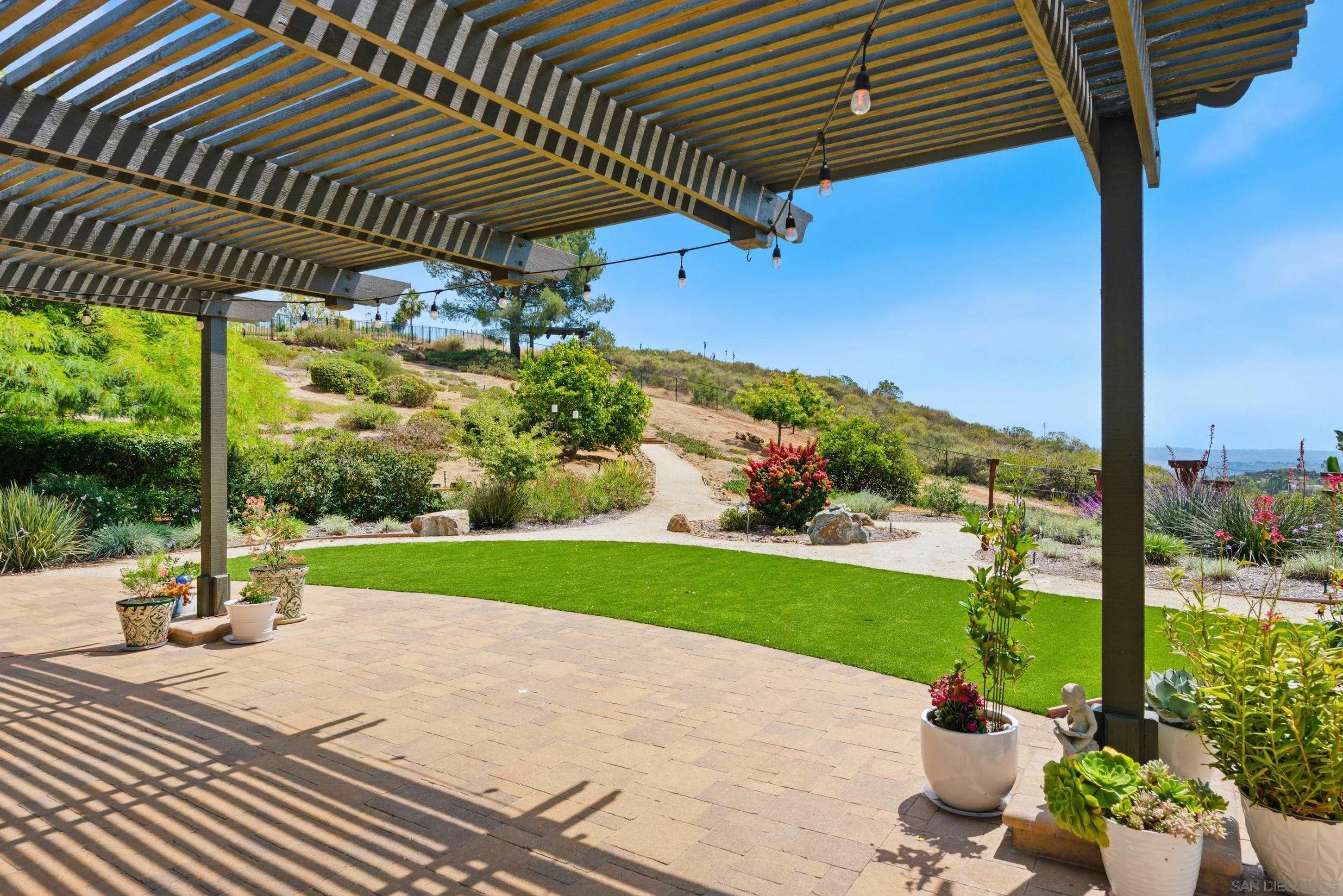 14505 Wildgrove Road Poway, CA 92064 - Photo 27 of 55 a backyard of a house with a garden and outdoor seating