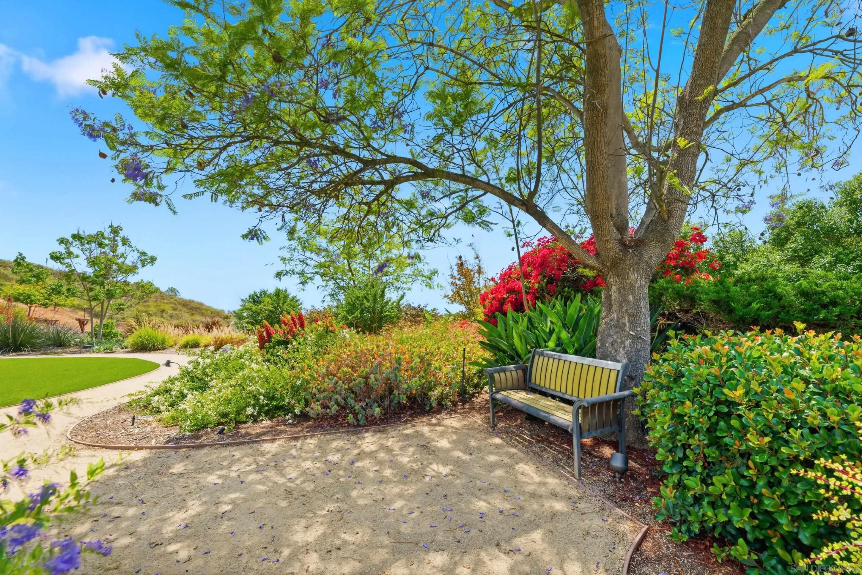 14505 Wildgrove Road Poway, CA 92064 - Photo 30 of 55 a wooden bench sitting in a yard with plants and large trees