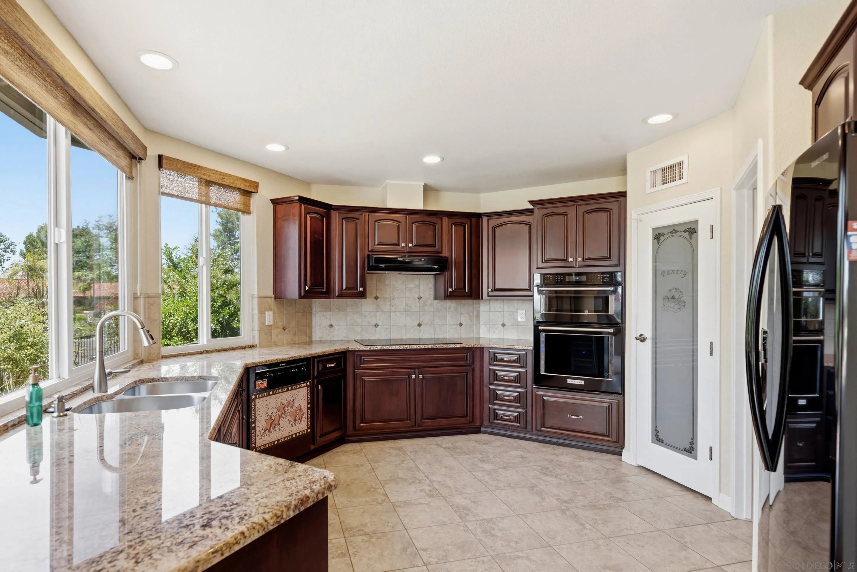 14505 Wildgrove Road Poway, CA 92064 - Photo 4 of 55 a large kitchen with stainless steel appliances granite countertop a stove refrigerator and cabinets