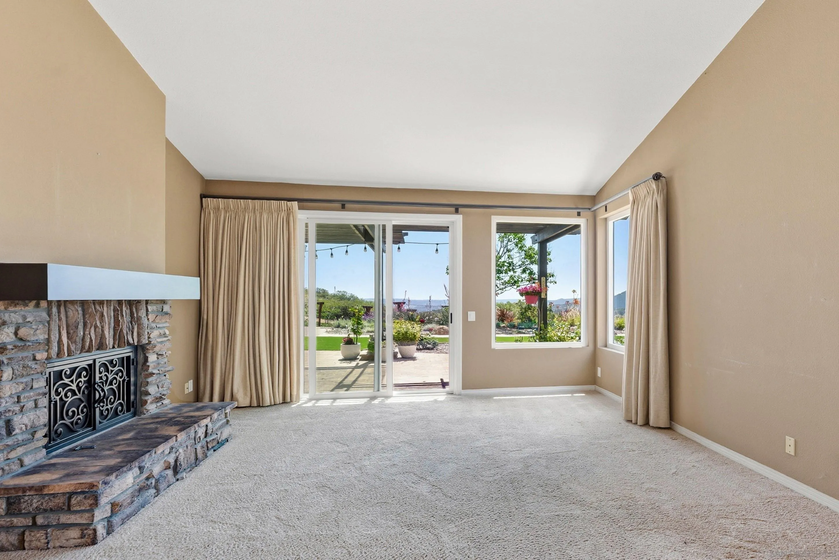 14505 Wildgrove Road Poway, CA 92064 - Photo 7 of 55 an empty room with floor to ceiling window and an outdoor view