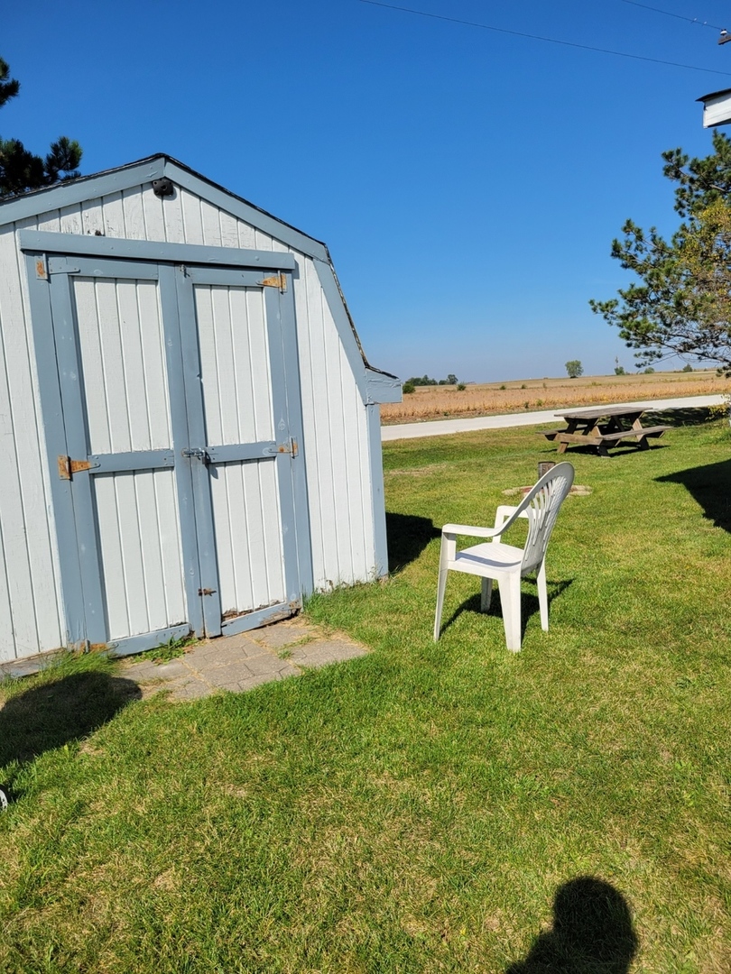 3 Drake Lane, Unit 3DRA Beecher, IL 60401 - Photo 18 of 18 a backyard of a house with table and chairs