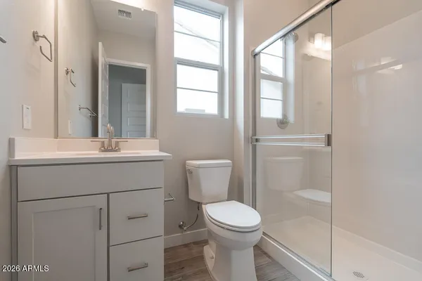 a bathroom with a toilet a sink and a mirror