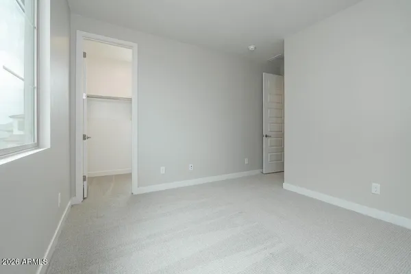 an empty room with windows and closet