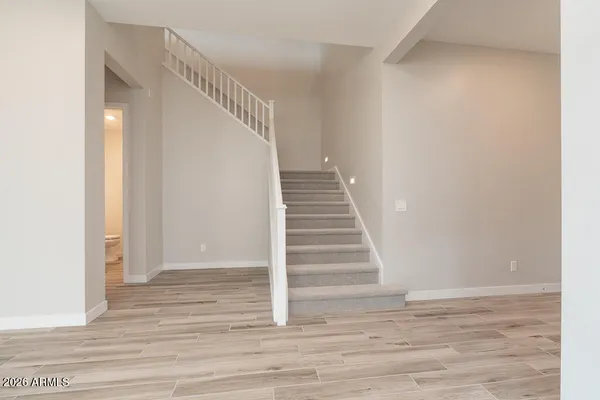 a view of entryway and hall with wooden floor