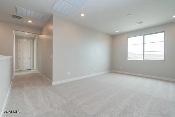 an empty room with windows and closet