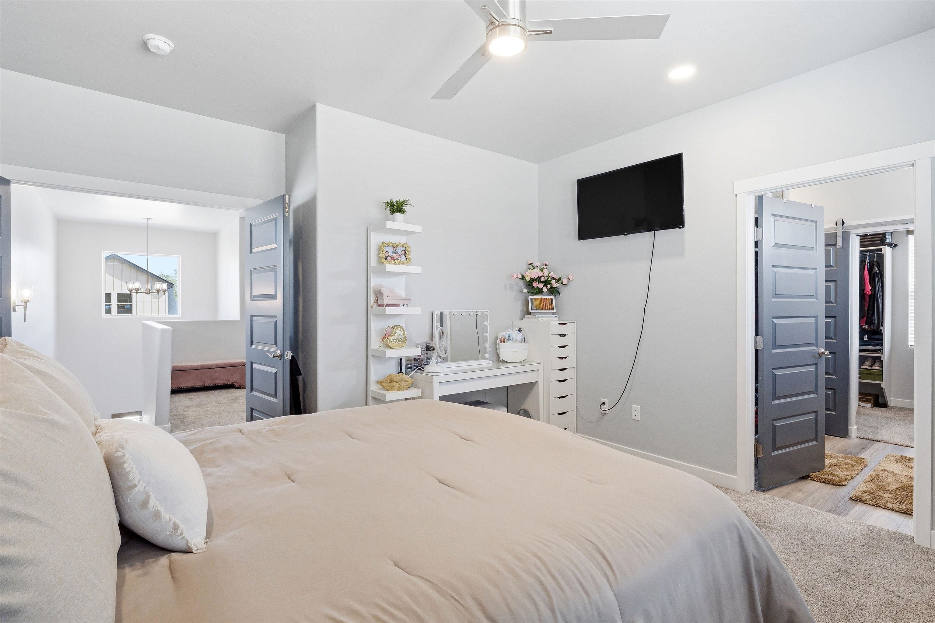2459 Hamilton Road, Unit A Grand Junction, CO 81505 - Photo 14 of 27 a bedroom with a bed and a flat tv screen on wall