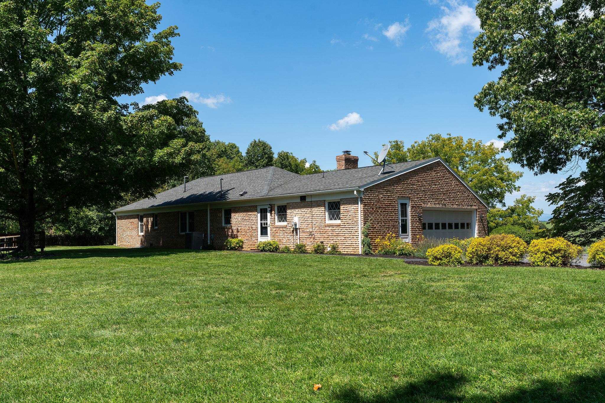 192 Galena Road Staunton, VA 24401 - Photo 38 of 75 a view of a house with a big yard and potted plants and large trees