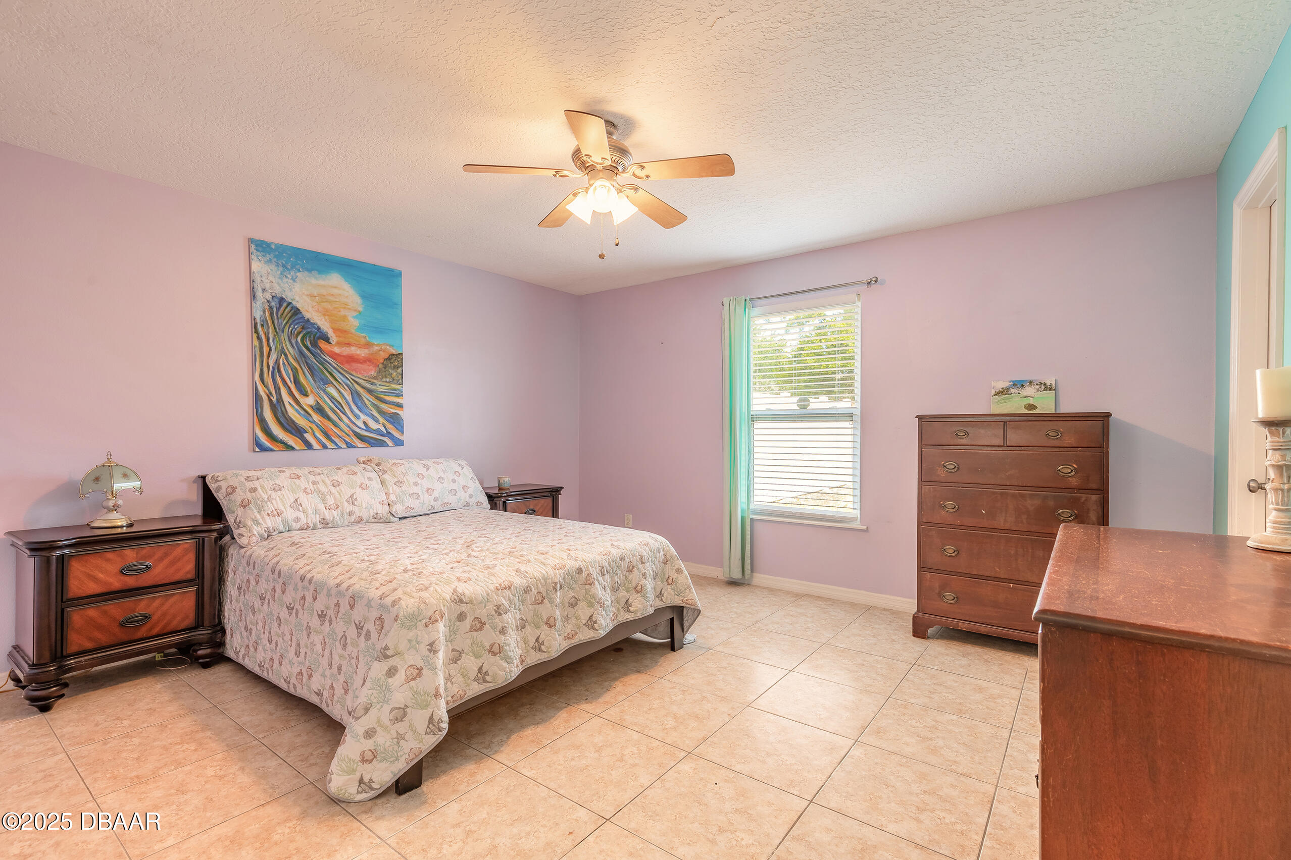 601 Sea Gull Court Edgewater, FL 32141 - Photo 11 of 25 a bedroom with a bed and a dresser