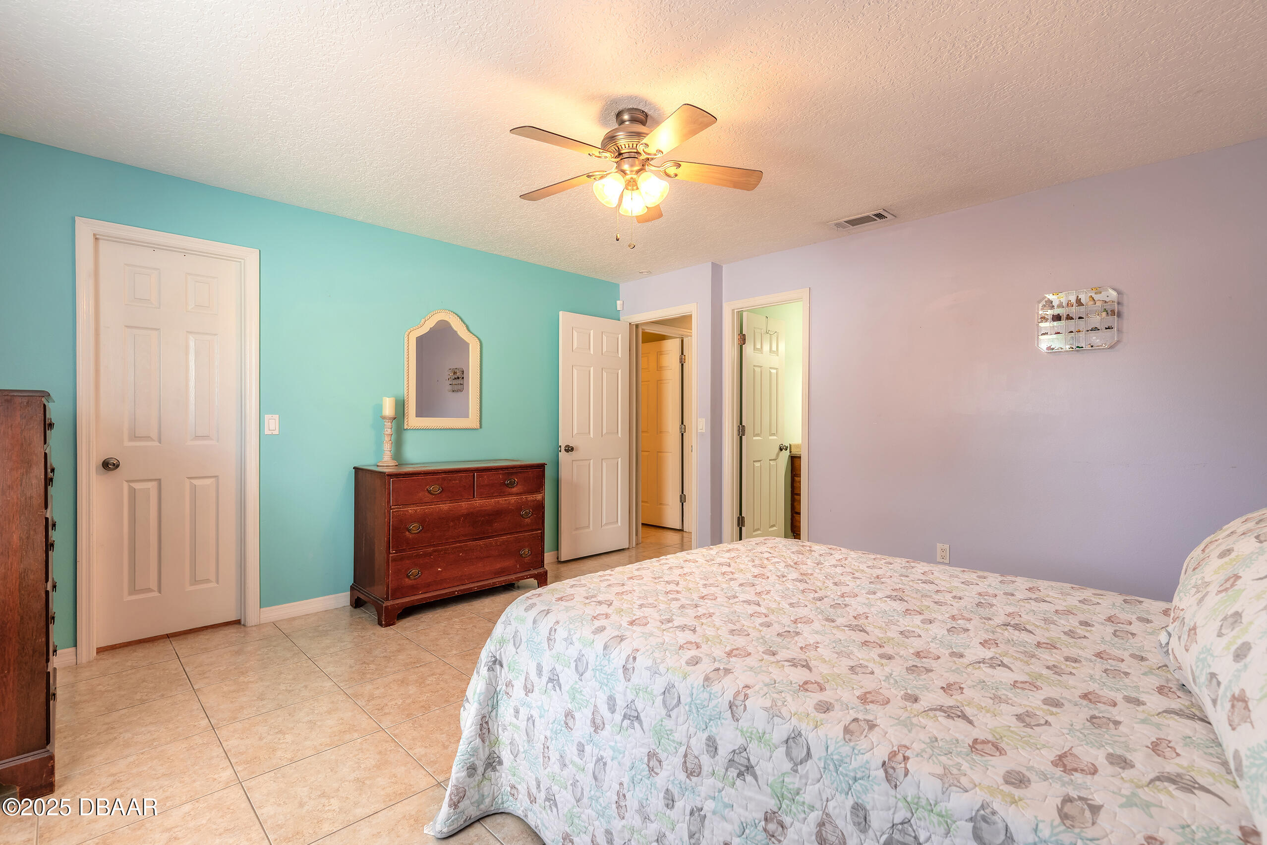 601 Sea Gull Court Edgewater, FL 32141 - Photo 12 of 25 a bedroom with a bed and a dresser