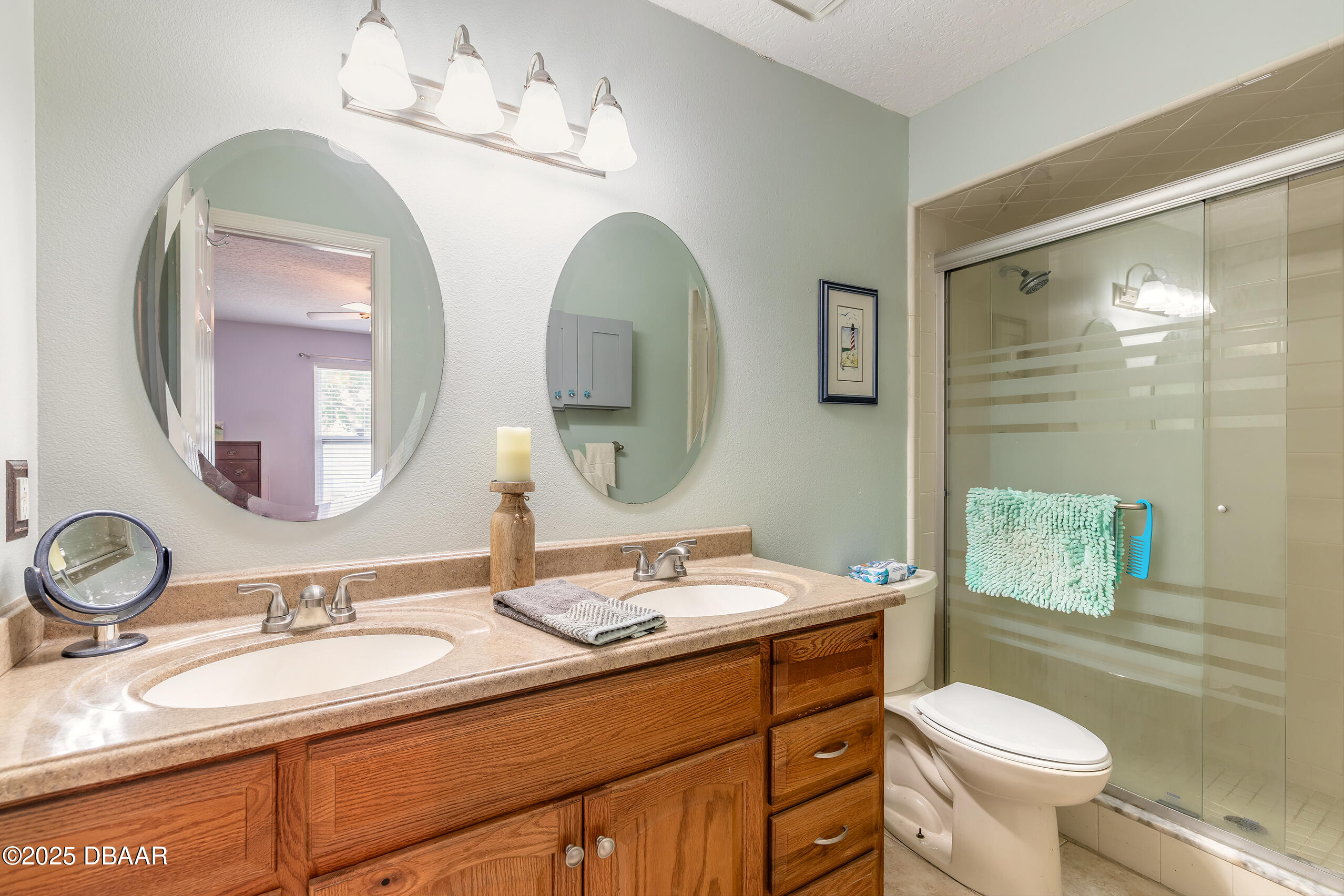 601 Sea Gull Court Edgewater, FL 32141 - Photo 13 of 25 a bathroom with a toilet a sink and mirror