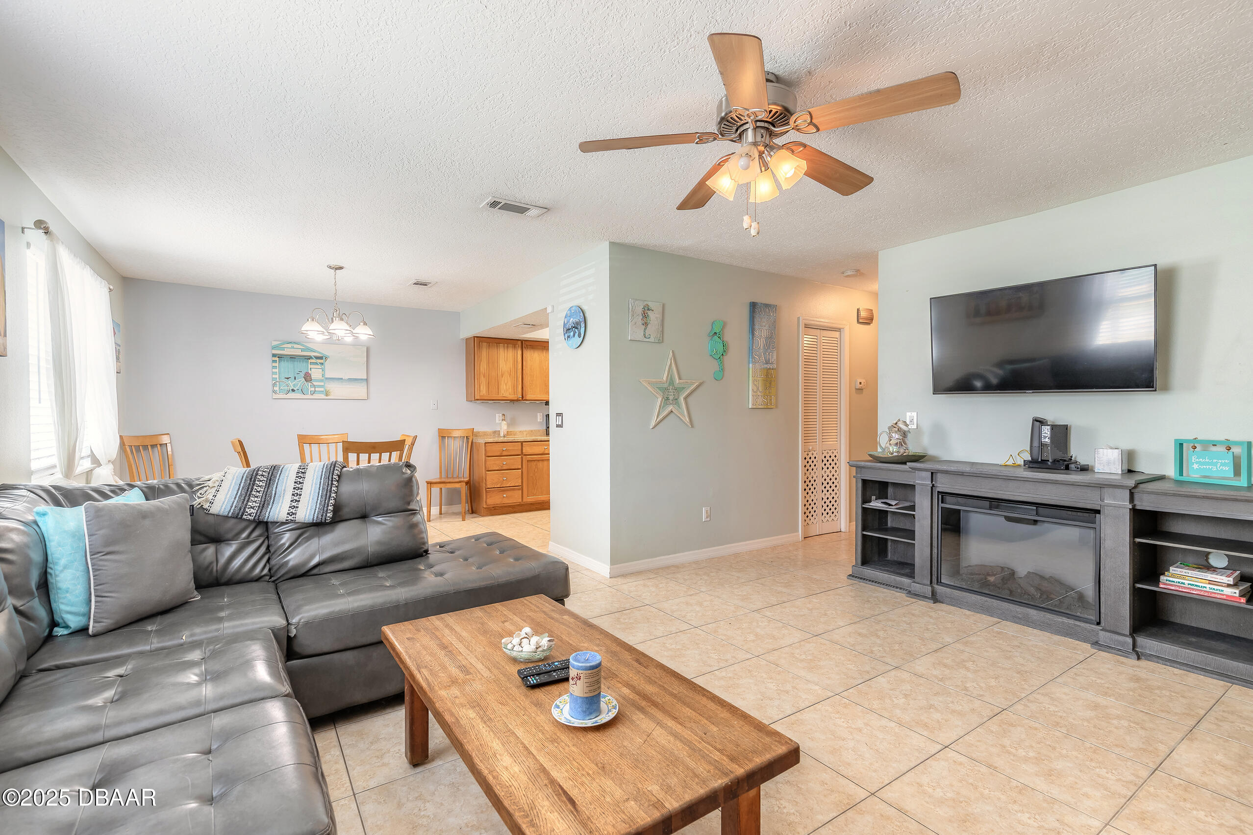 601 Sea Gull Court Edgewater, FL 32141 - Photo 7 of 25 a living room with furniture and a flat screen tv